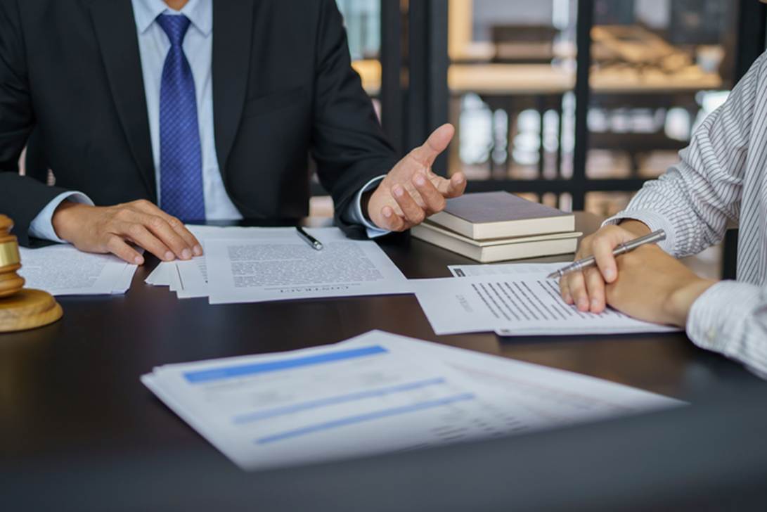 A person and person sitting at a table with papers and pen

AI-generated content may be incorrect.